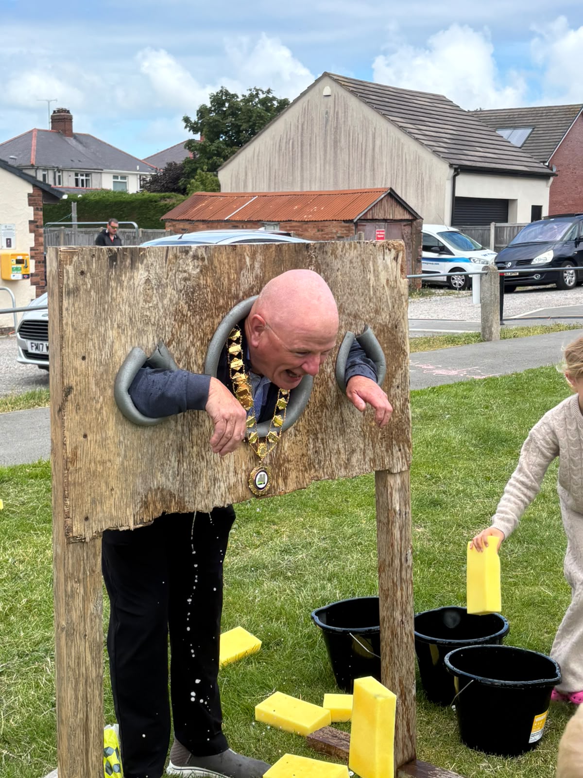 Deputy Mayor Cllr Mike Elgin in the stocks at Credu Connecting Carers Fun Day
